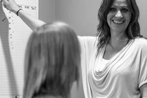 Lady pointing at a board in a training session