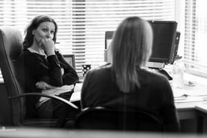Two women talking at a desk
