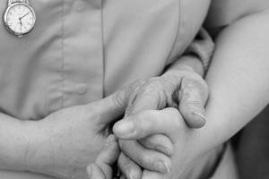 A lady holding another lady's hand