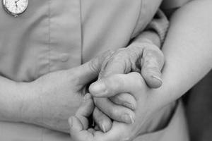 A lady holding another lady's hand