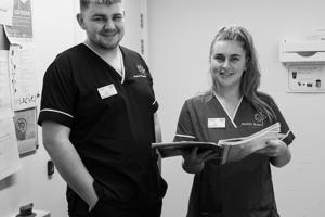 Young male and female social care worker smiling