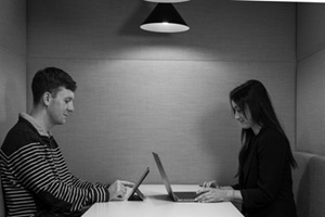 Two people on laptops