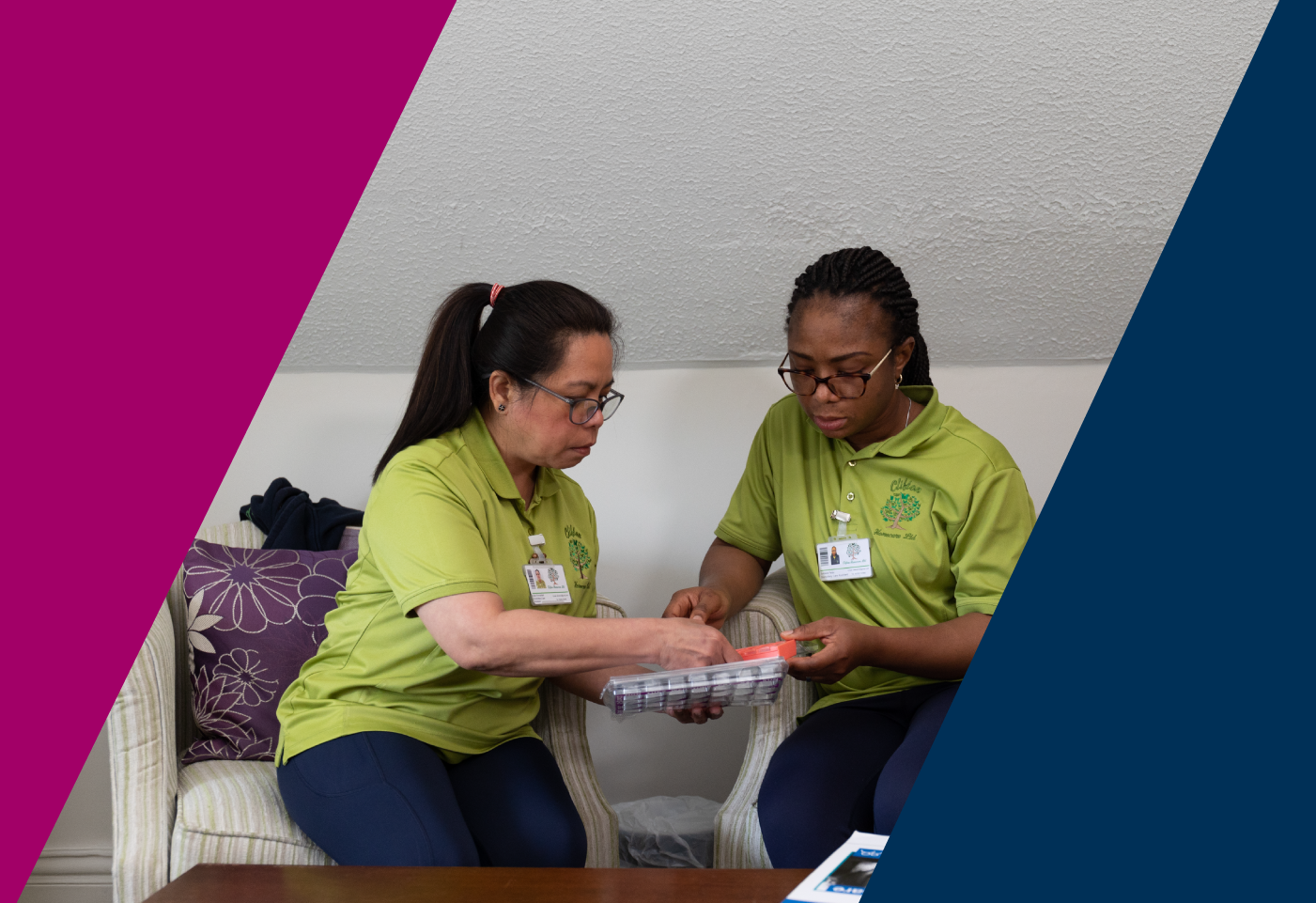 two care workers discuss a piece of equipment 