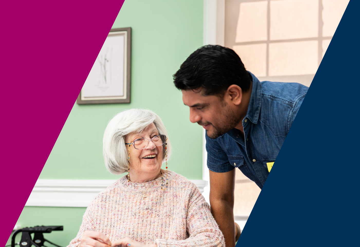 a care worker laughs with a resident